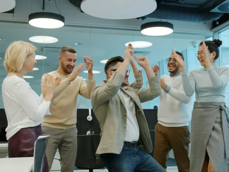 Colleagues celebrating a project milestone in the office
